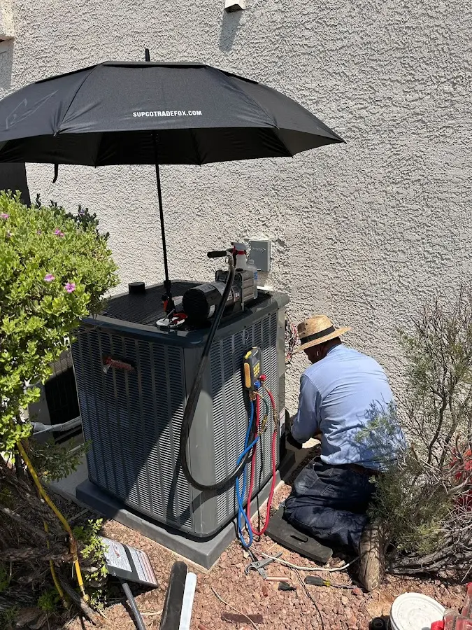 HVAC technician performing outdoor AC maintenance in Huntington
